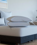 Detailansicht von zwei weißen Kissenschonbezügen auf einem modernen Bett, mit glatter Oberfläche und hochwertiger Verarbeitung für optimalen Kissenschutz